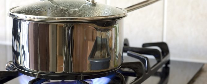A stainless steel pot on a gas stove